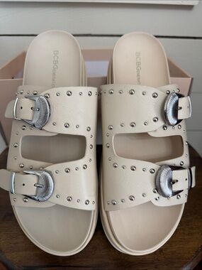 BCBGeneration Ivory Slide Sandals with Silver Buckles